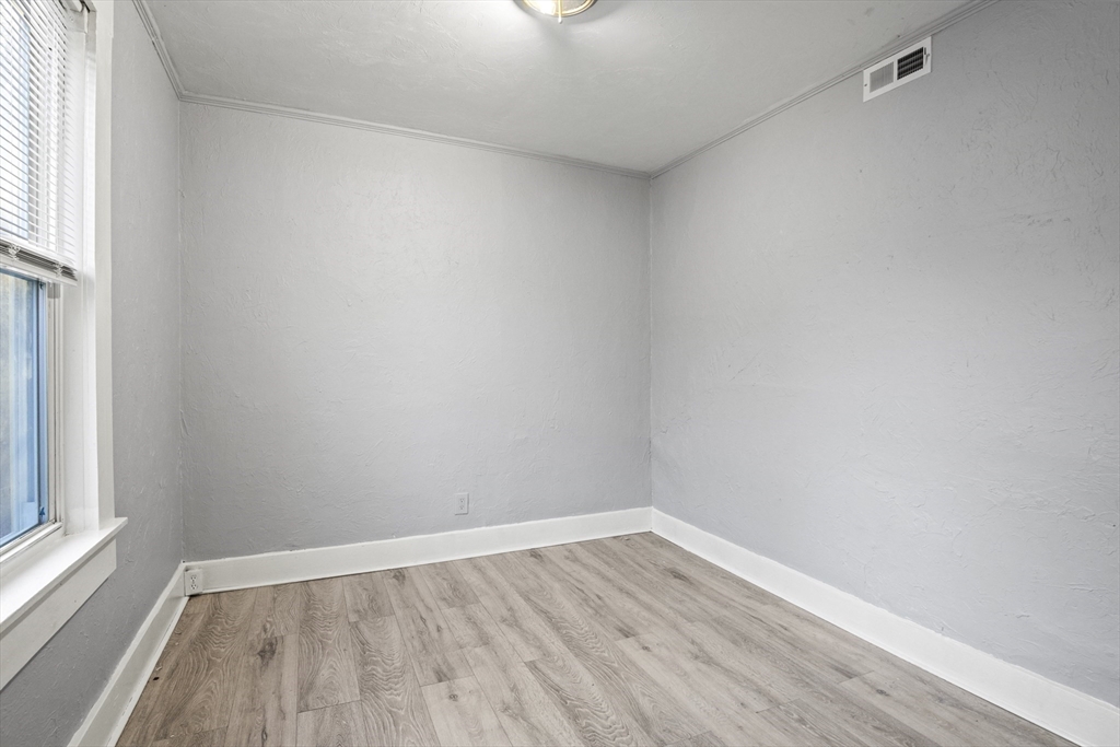 78 Greenwood Street Worcester, MA 01607 - Photo 14 of 33 a view of an empty room with wooden floor and a window