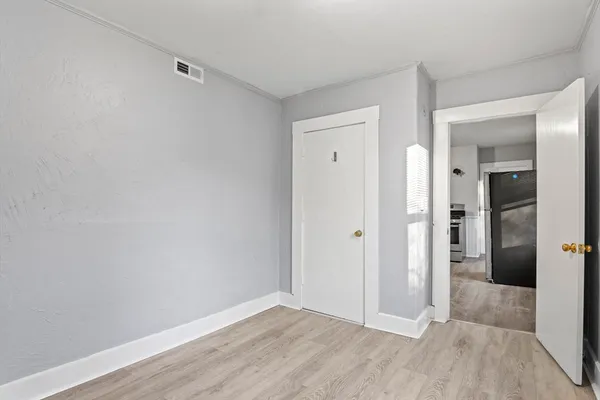wooden floor in a hall with an empty room