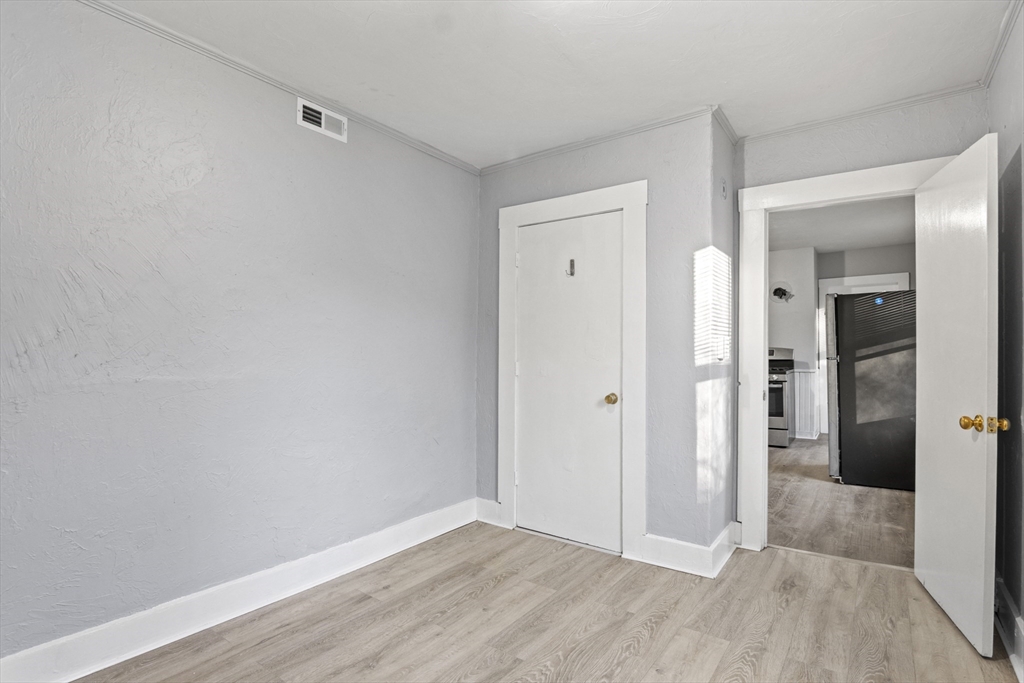 78 Greenwood Street Worcester, MA 01607 - Photo 15 of 33 wooden floor in a hall with an empty room