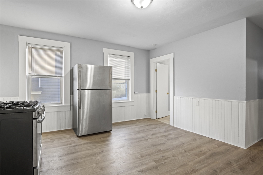 78 Greenwood Street Worcester, MA 01607 - Photo 16 of 33 a view of a kitchen with refrigerator and wooden floor