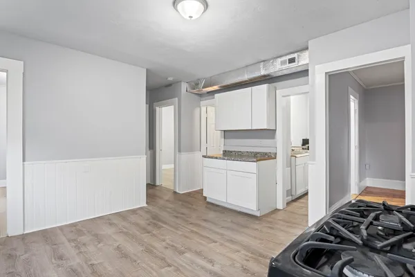 a kitchen with a refrigerator and a stove top oven