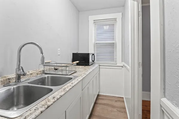 a kitchen with a sink and a microwave