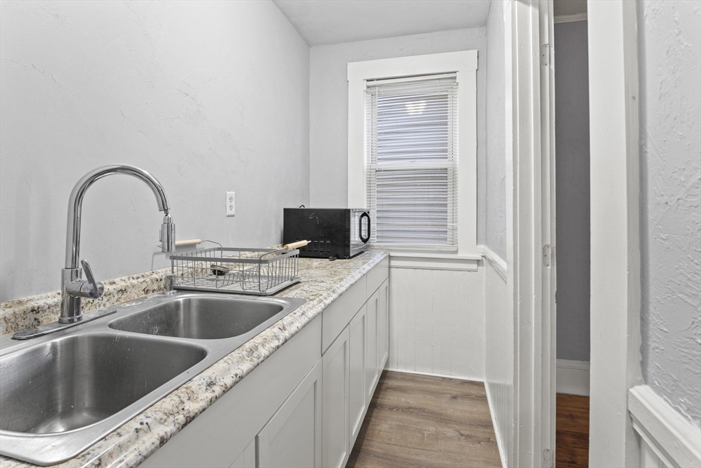 78 Greenwood Street Worcester, MA 01607 - Photo 20 of 33 a kitchen with a sink and a microwave