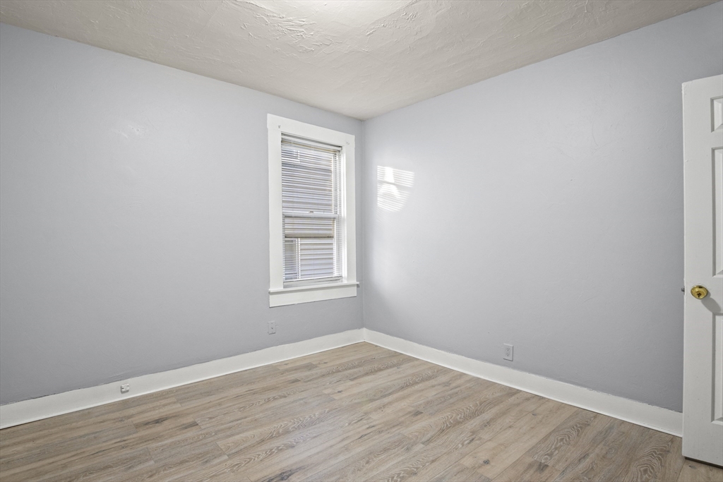 78 Greenwood Street Worcester, MA 01607 - Photo 22 of 33 an empty room with wooden floor and windows
