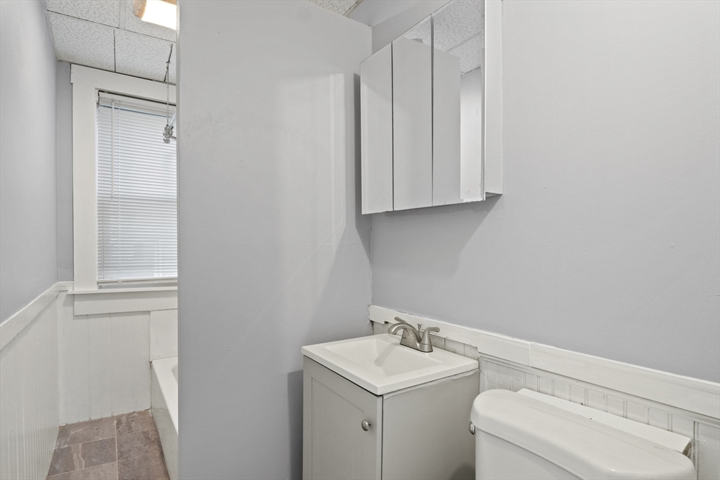 78 Greenwood Street Worcester, MA 01607 - Photo 24 of 33 a bathroom with a toilet a sink and a window