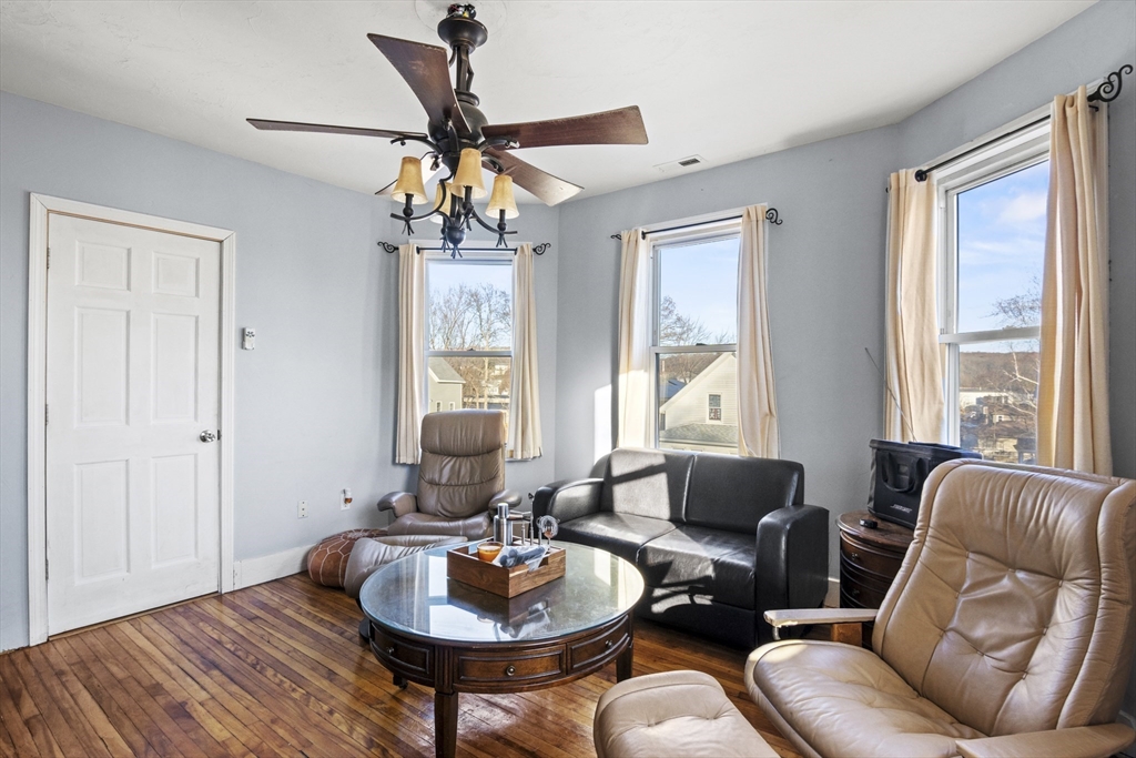 78 Greenwood Street Worcester, MA 01607 - Photo 26 of 33 a living room with furniture a chandelier and wooden floor
