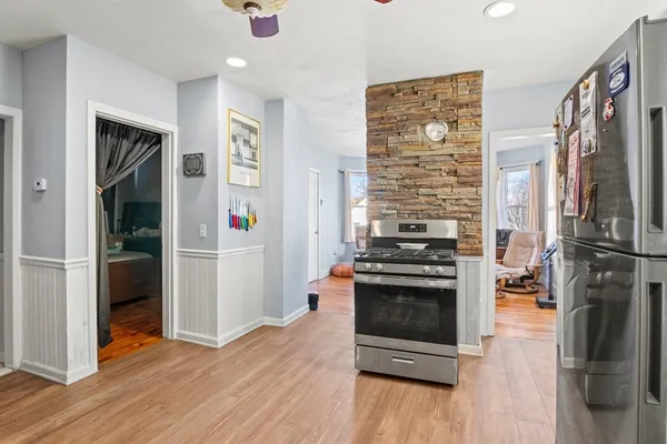 a kitchen with stainless steel appliances a stove a refrigerator and a refrigerator