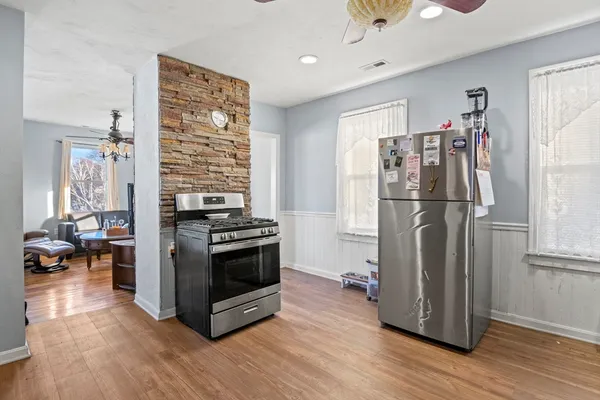 a kitchen with stainless steel appliances granite countertop a refrigerator and a stove