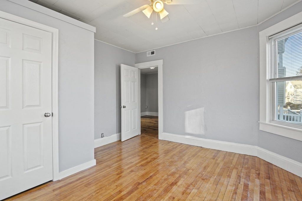 78 Greenwood Street Worcester, MA 01607 - Photo 6 of 33 an empty room with wooden floor and windows