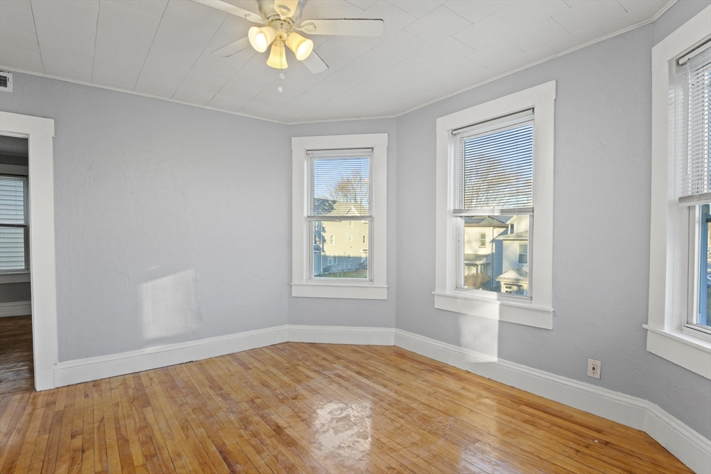 78 Greenwood Street Worcester, MA 01607 - Photo 7 of 33 a view of empty room with wooden floor and fan