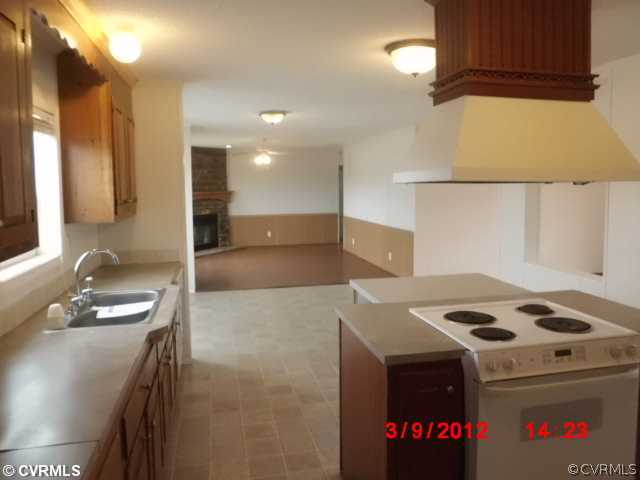 3709 Wakema Road West Point, VA 23181 - Photo 2 of 8 a kitchen with a stove a sink and a refrigerator
