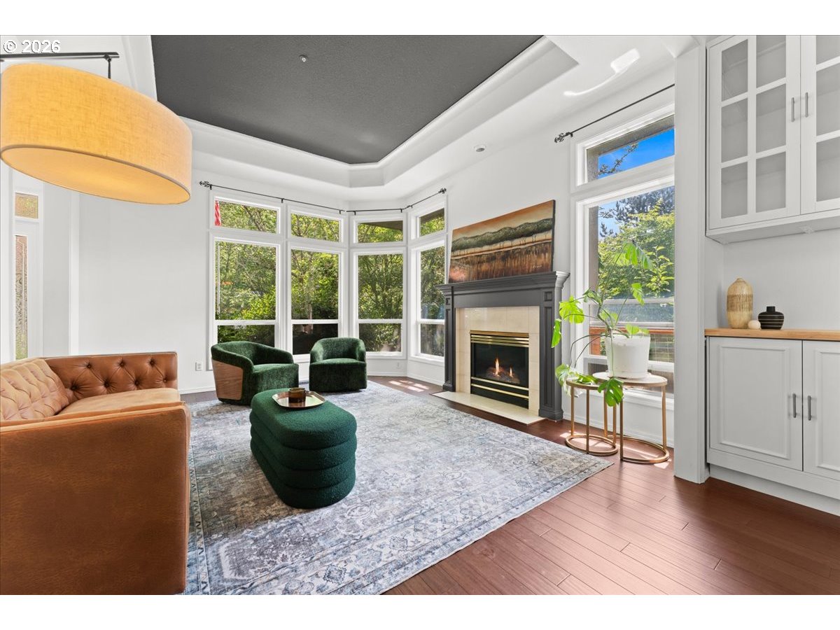 12431 Southwest 55th Place Portland, OR 97219 - Photo 4 of 40 a living room with furniture a fireplace and a floor to ceiling window
