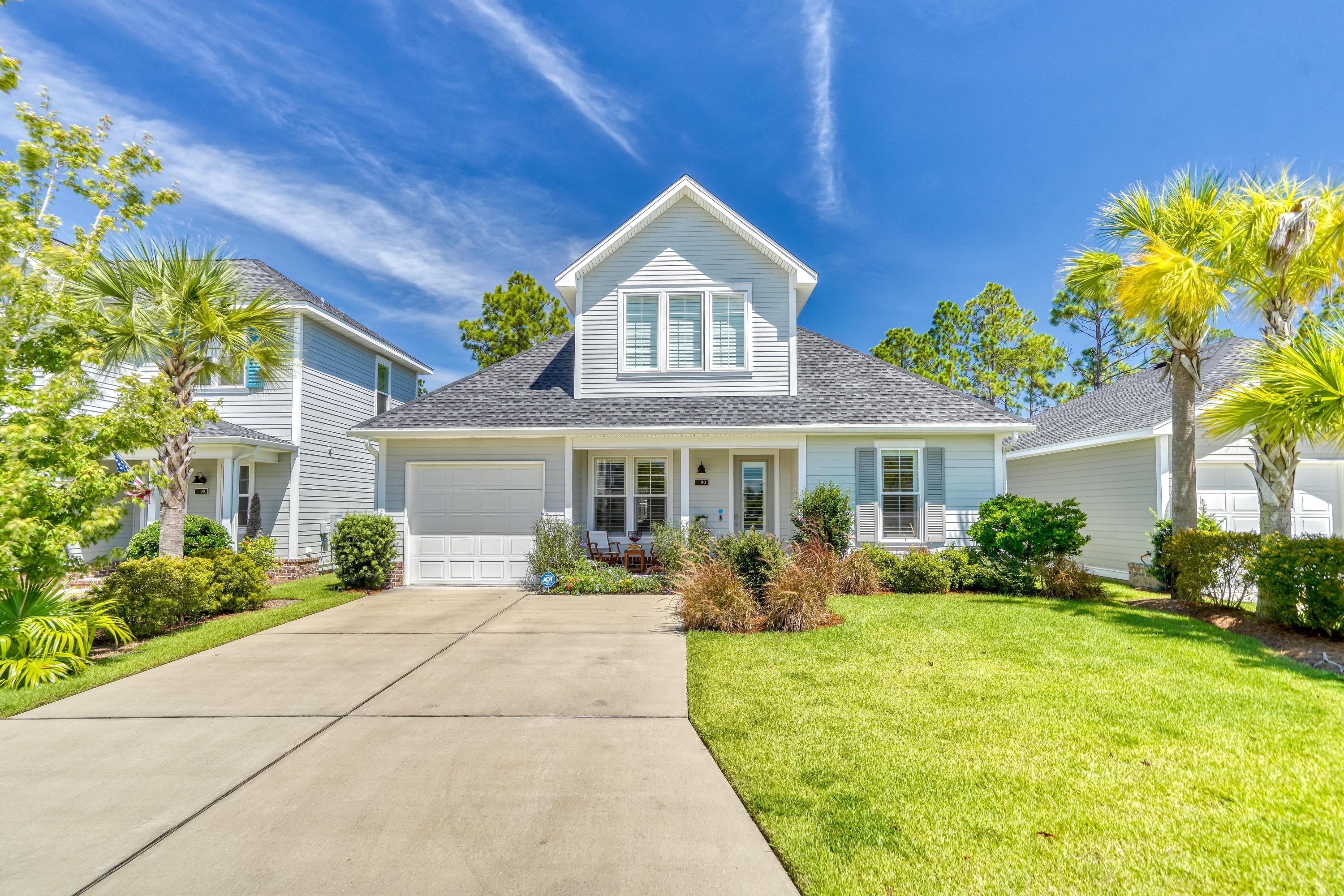 80 North Zander Way Santa Rosa Beach, FL 32459 - Photo 1 of 49 a front view of a house with a yard and potted plants