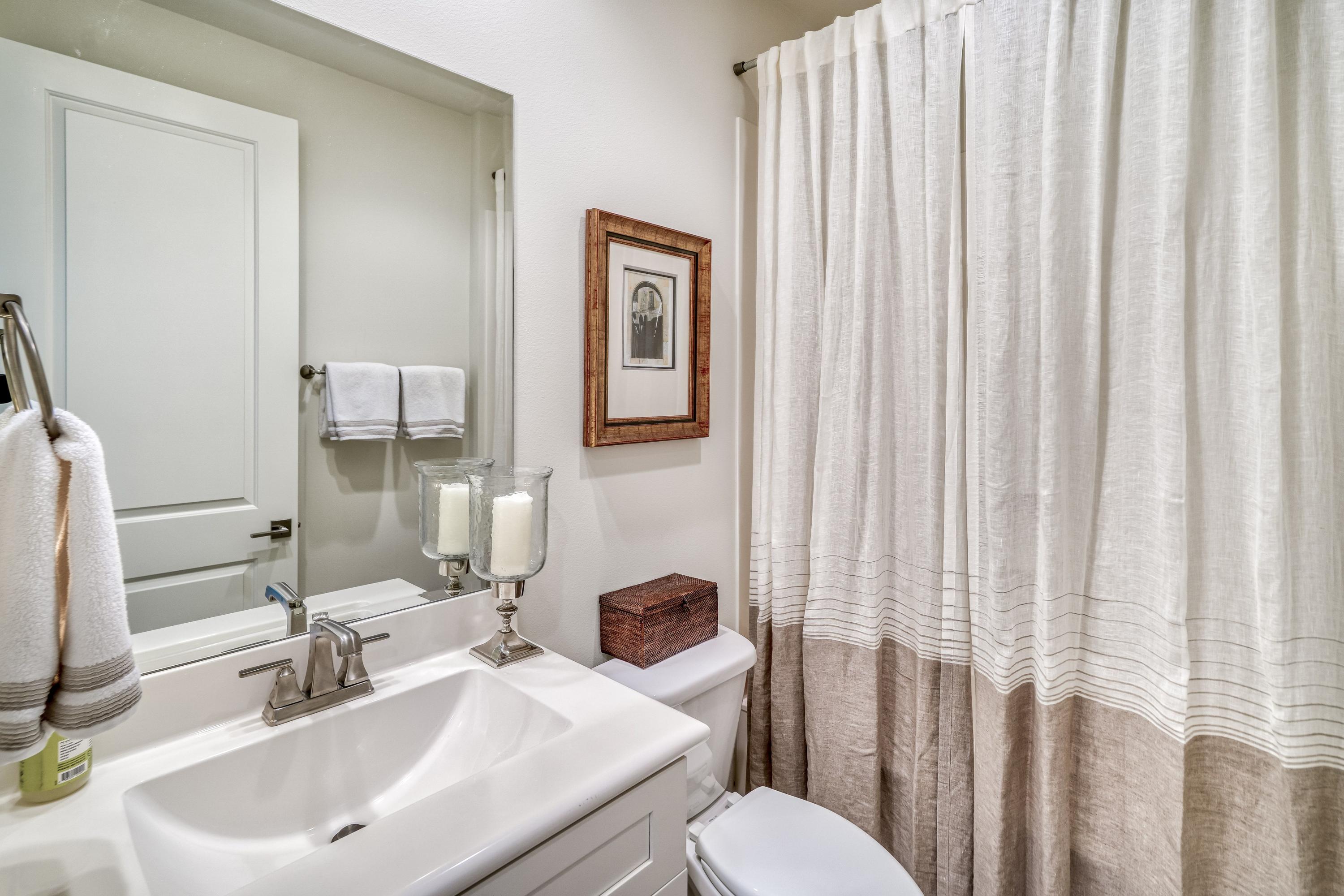 80 North Zander Way Santa Rosa Beach, FL 32459 - Photo 13 of 49 a bathroom with a toilet a sink and a mirror