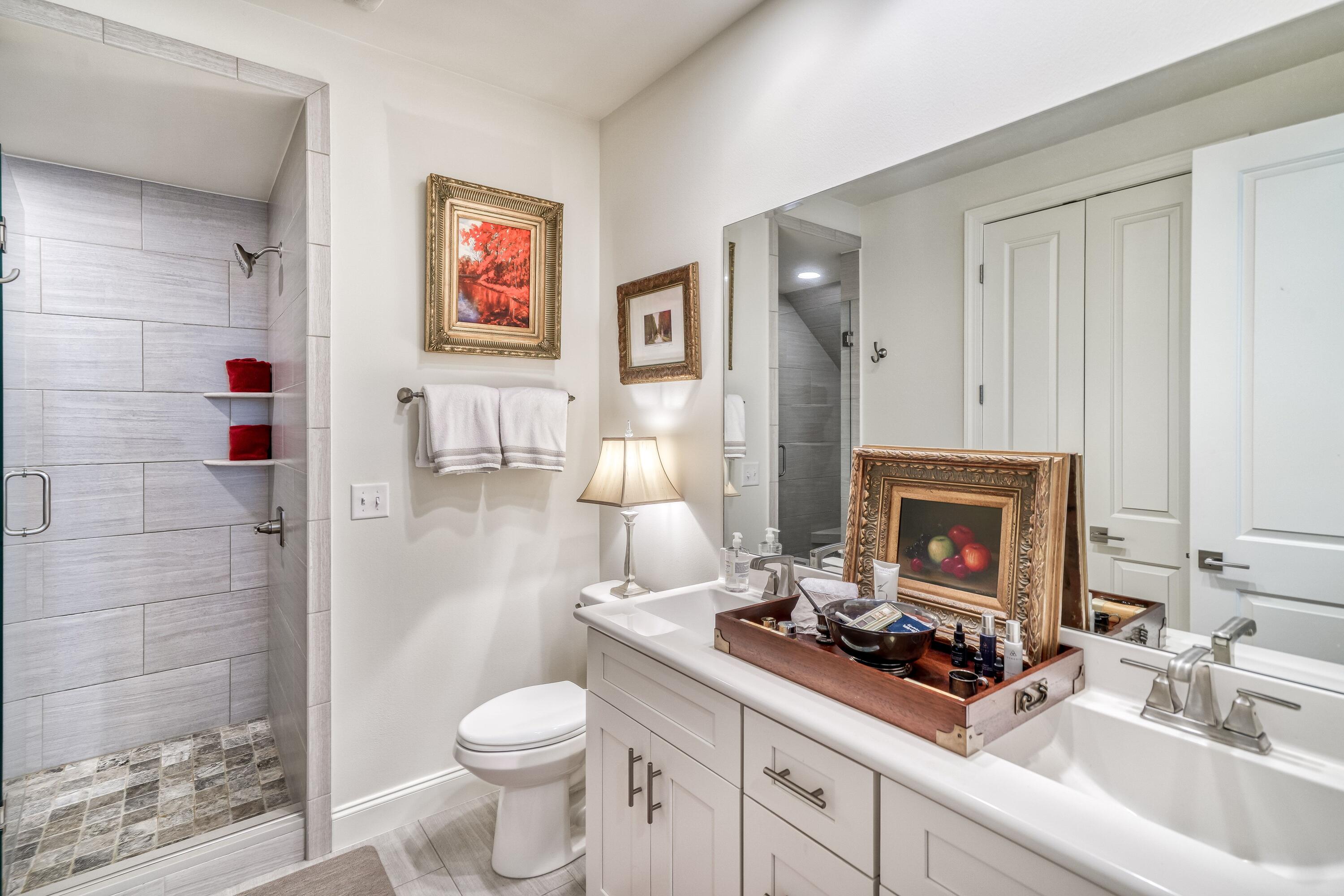 80 North Zander Way Santa Rosa Beach, FL 32459 - Photo 14 of 49 a bathroom with a toilet sink and mirror