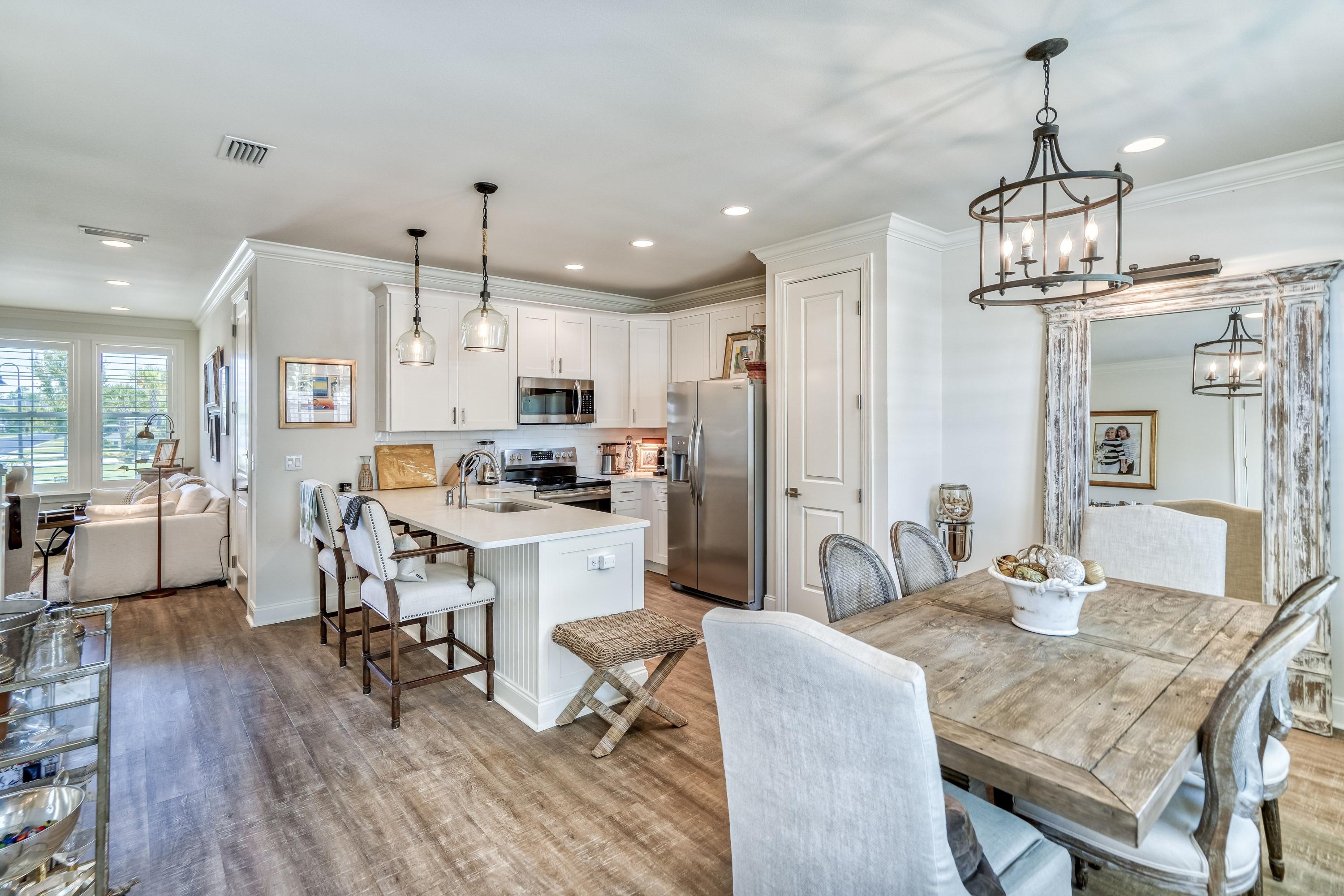 80 North Zander Way Santa Rosa Beach, FL 32459 - Photo 20 of 49 a kitchen with stainless steel appliances granite countertop a dining table chairs refrigerator and cabinets