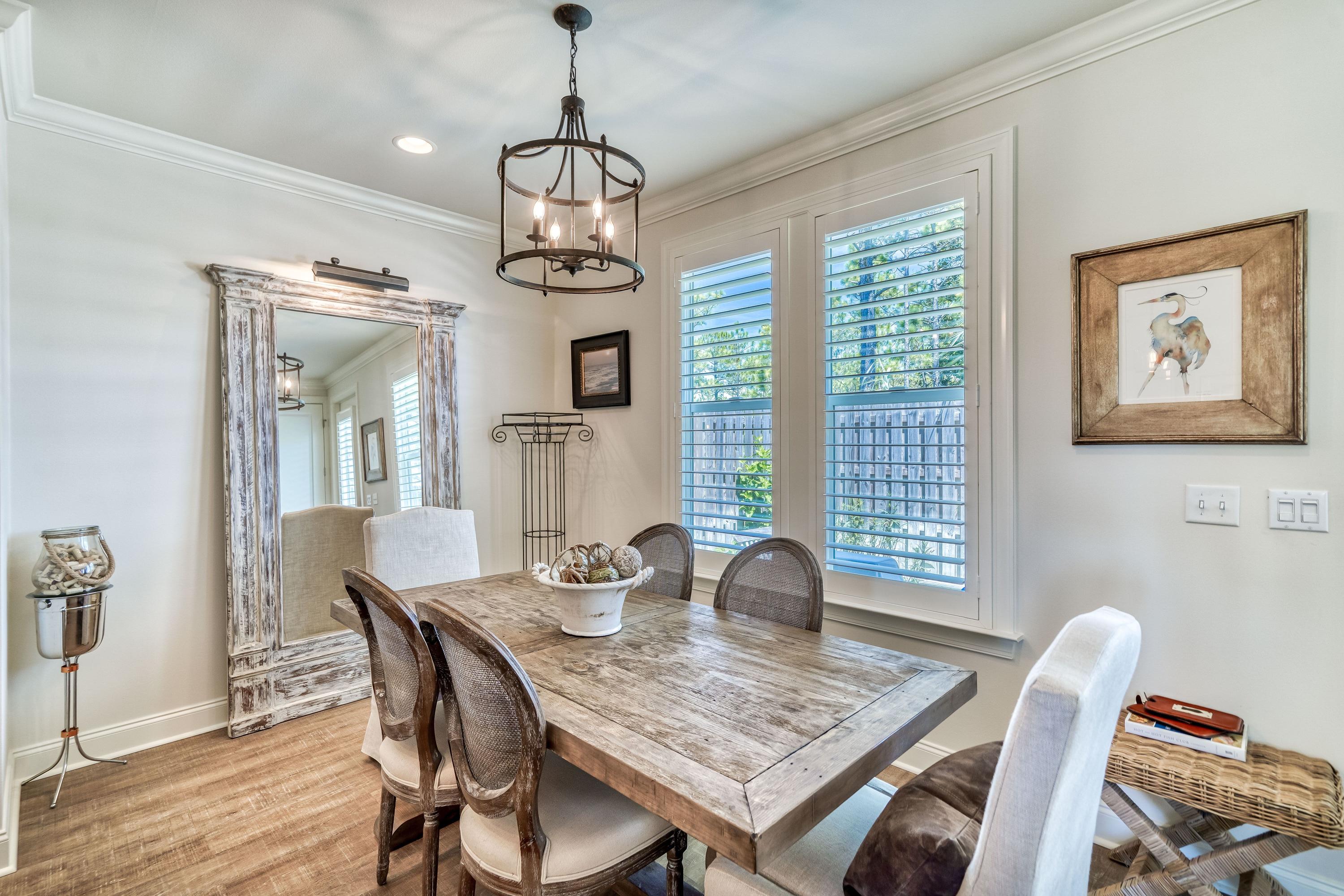 80 North Zander Way Santa Rosa Beach, FL 32459 - Photo 22 of 49 a view of a dining room with furniture window and wooden floor