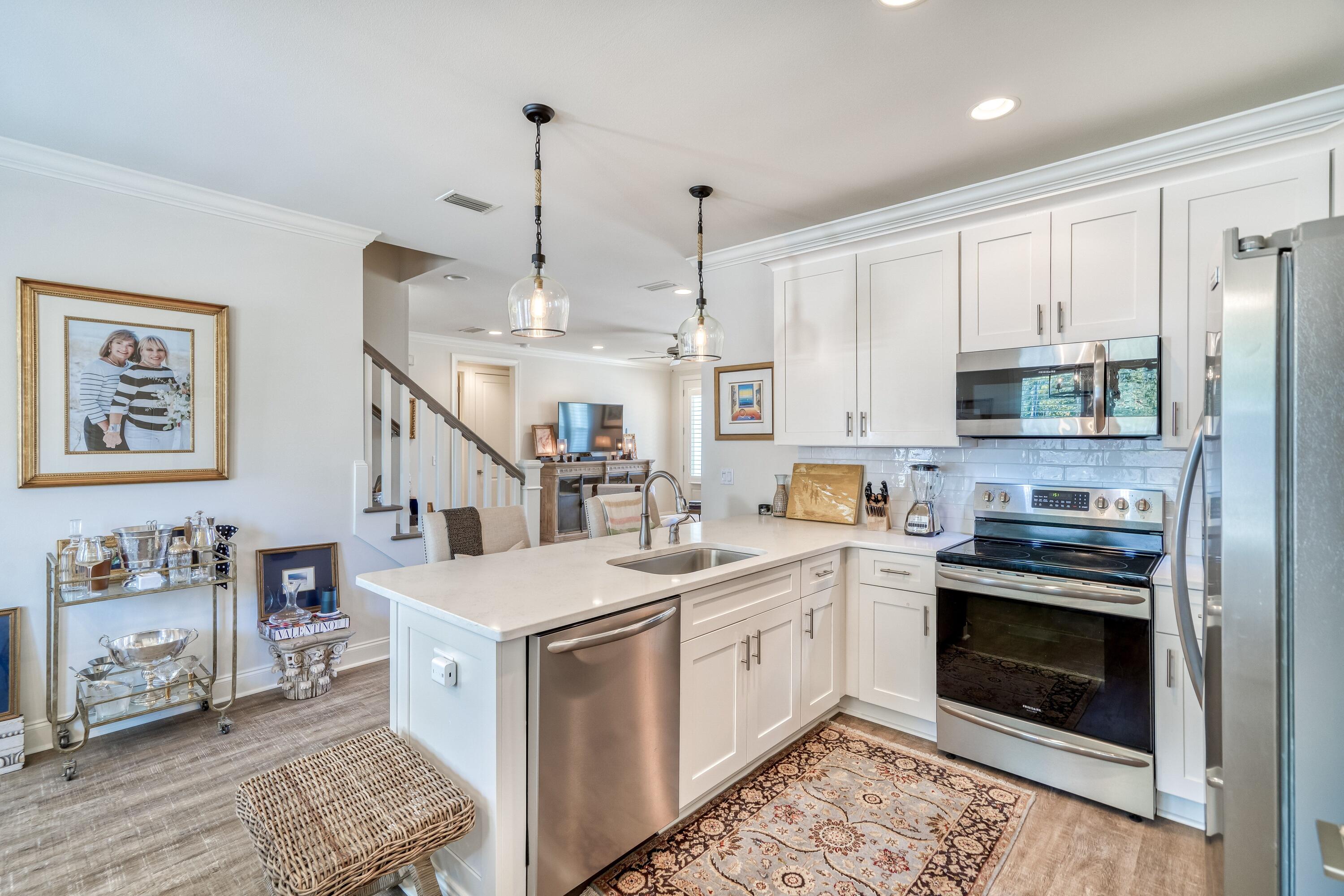 80 North Zander Way Santa Rosa Beach, FL 32459 - Photo 25 of 49 a kitchen with stainless steel appliances granite countertop a stove sink and cabinets