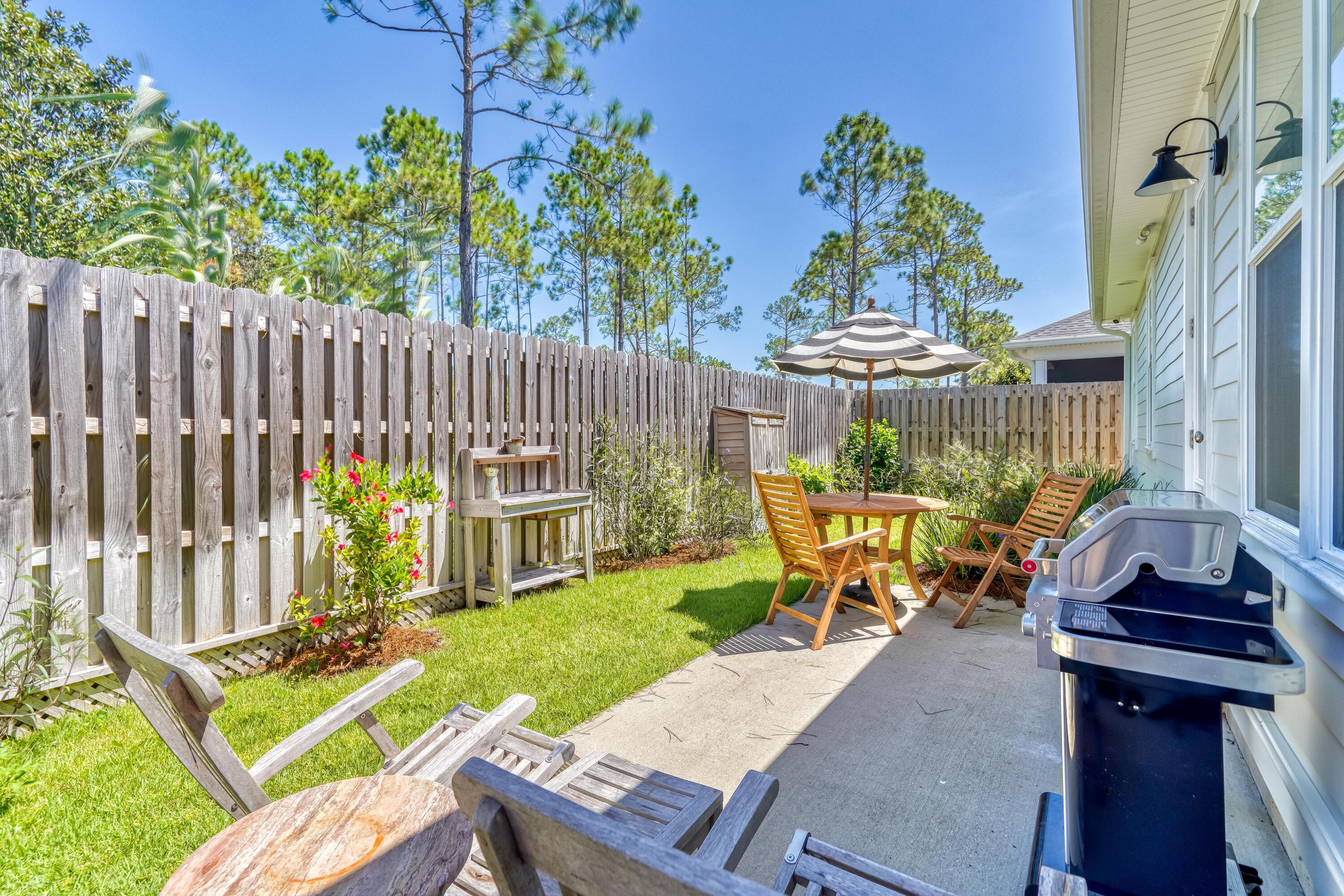 80 North Zander Way Santa Rosa Beach, FL 32459 - Photo 32 of 49 a view of a chair and table in backyard of the house