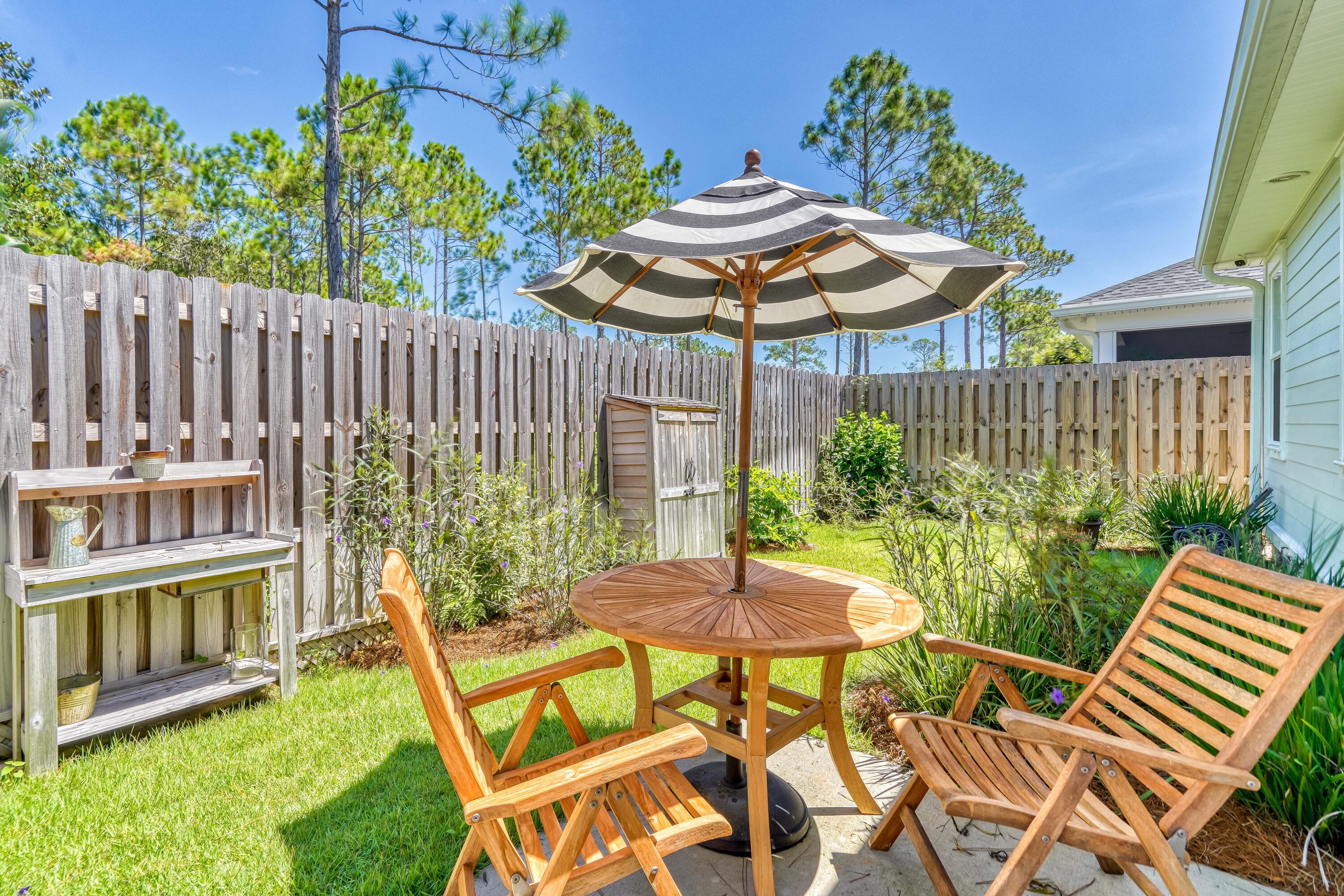 80 North Zander Way Santa Rosa Beach, FL 32459 - Photo 33 of 49 a view of a chair and table in backyard of the house
