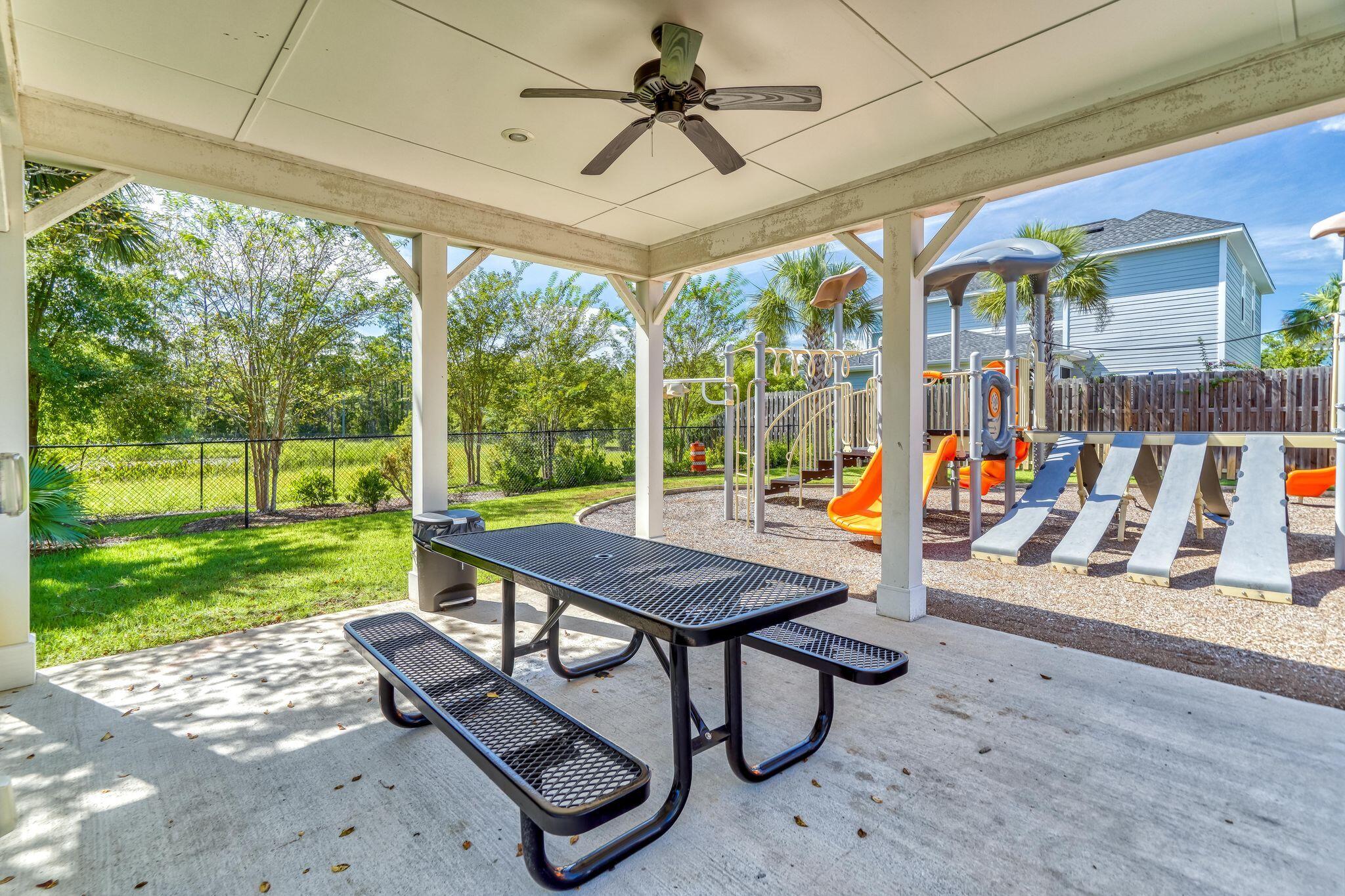 80 North Zander Way Santa Rosa Beach, FL 32459 - Photo 39 of 49 a view of a patio with a table chairs and a yard
