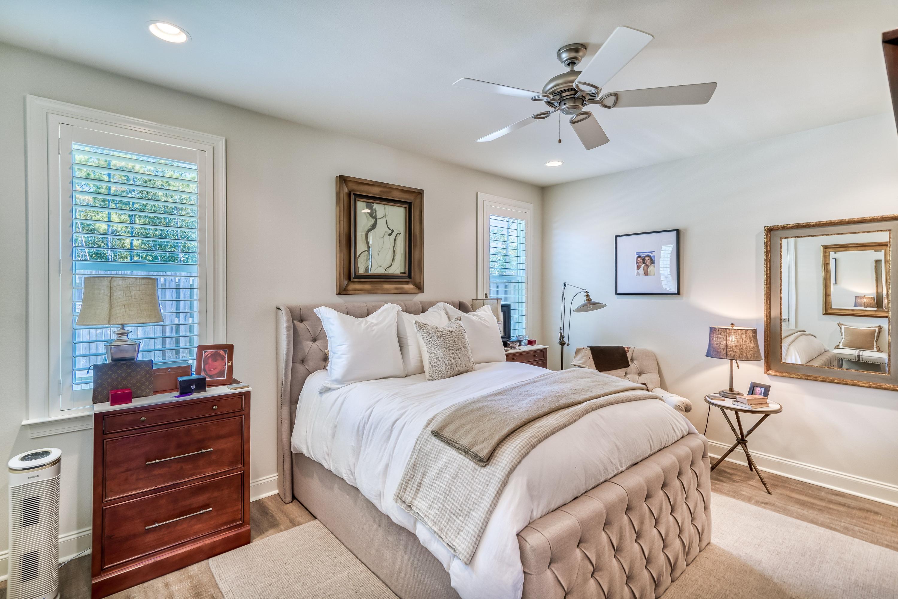 80 North Zander Way Santa Rosa Beach, FL 32459 - Photo 9 of 49 a bedroom with bed and a chandelier