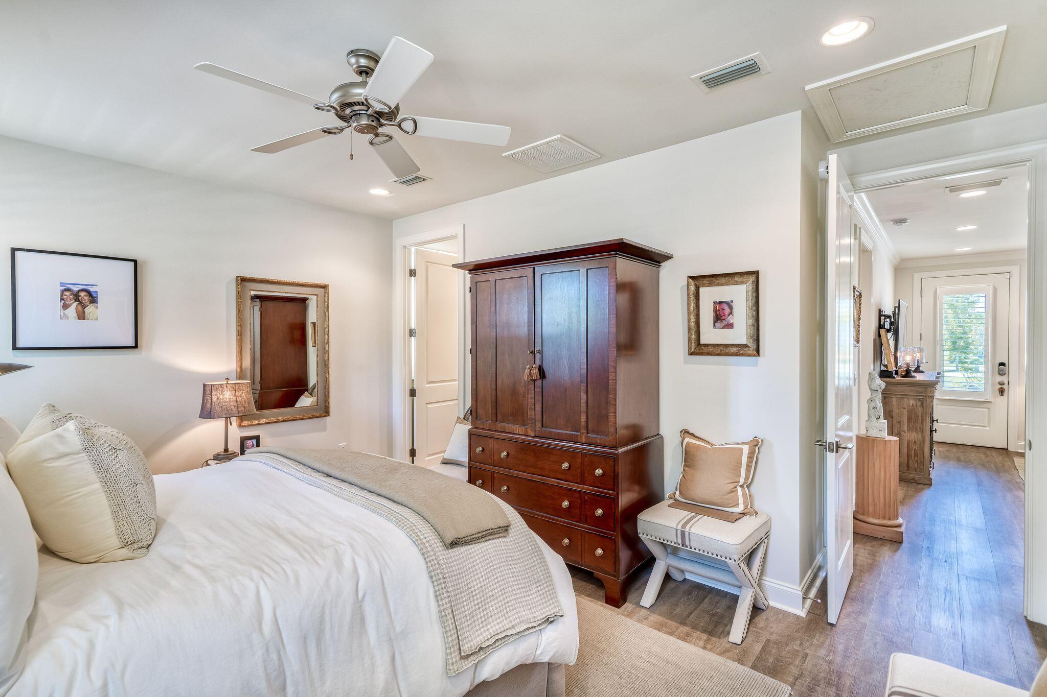 80 North Zander Way Santa Rosa Beach, FL 32459 - Photo 10 of 49 a bedroom with a bed and a chandelier