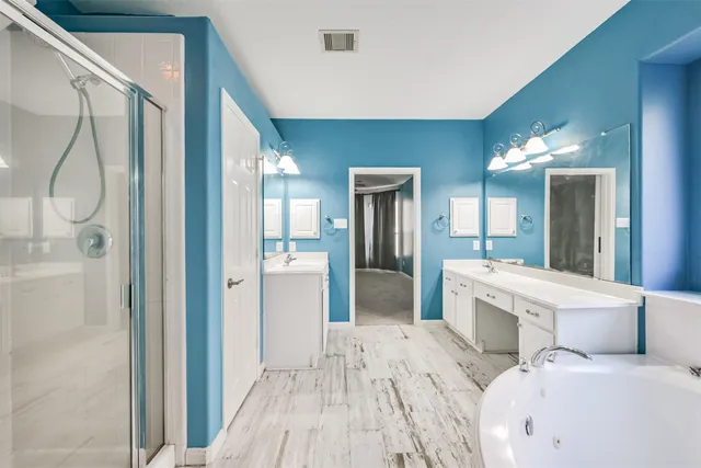 a bathroom with a sink and mirror with toilet