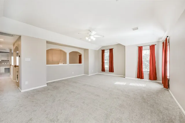 a view of an empty room with window and closet