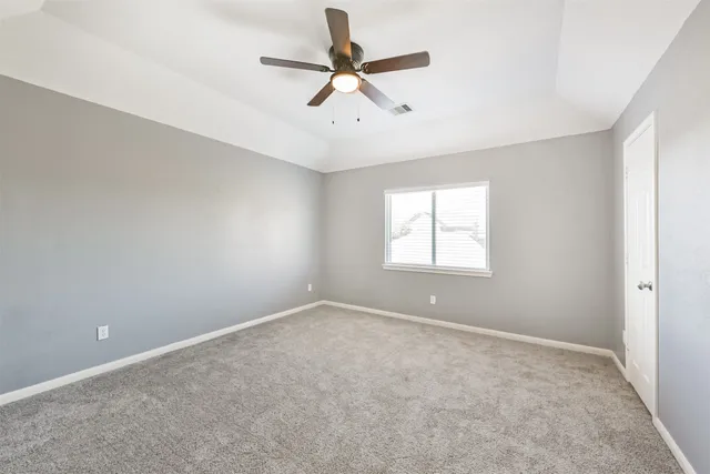 a view of room with a ceiling fan and window