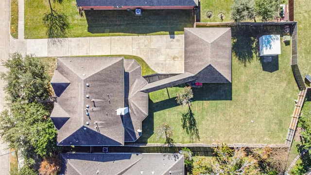 an aerial view of a house with a yard