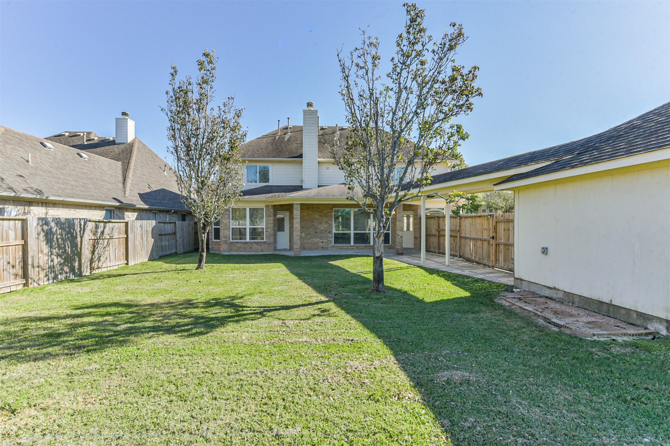 3919 Copper Creek Baytown, TX 77521 - Photo 49 of 50 a yellow house sitting in middle of the middle of a park