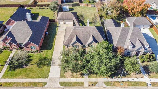 an aerial view of a house with a yard and lake view