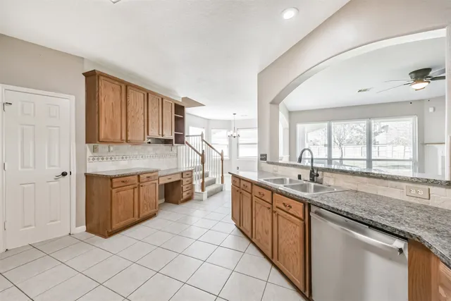 a kitchen with stainless steel appliances granite countertop a sink and cabinets
