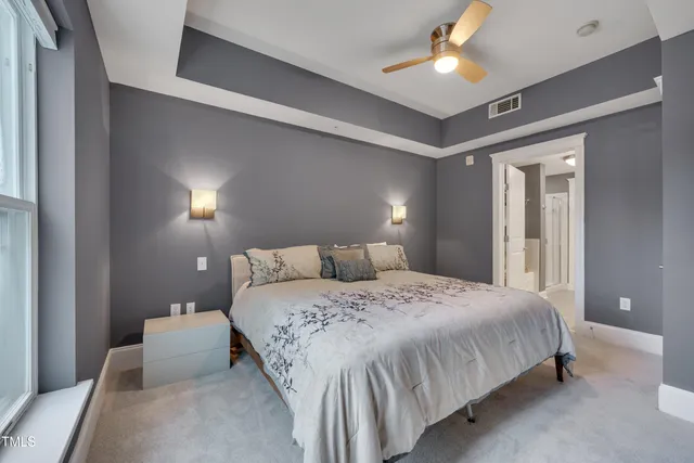 a bedroom with a bed and a lamp