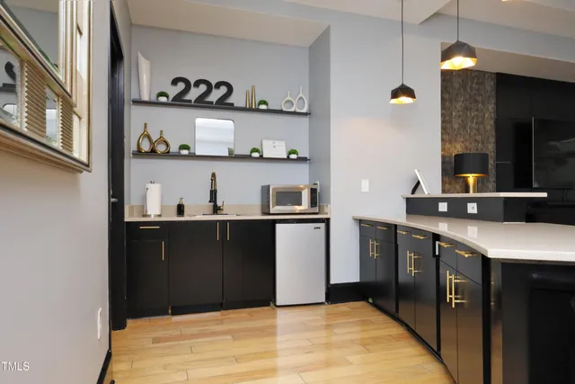 a kitchen with stainless steel appliances granite countertop a refrigerator and cabinets