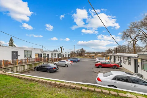 a view of a terrace with lawn chairs