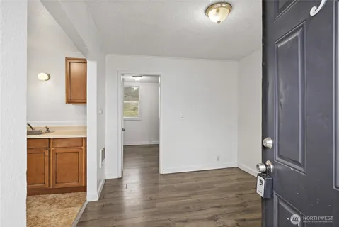 a view of a kitchen from the hallway with a sink