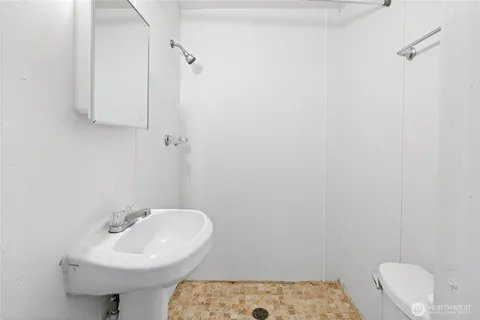 a bathroom with a sink a mirror and a toilet