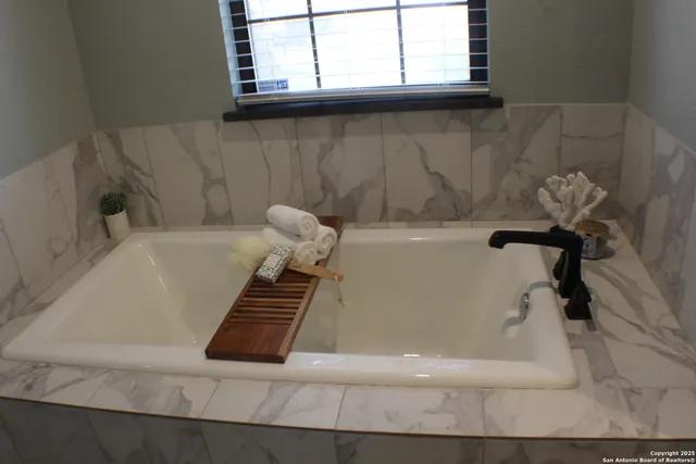 a view of a room with wooden floor and windows
