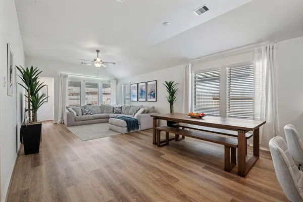a living room with furniture and a potted plant