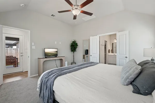 a bedroom with a bed and ceiling fan