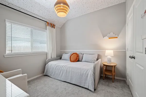 a bedroom with a bed and window