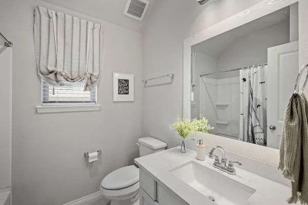 a bathroom with a sink toilet and mirror