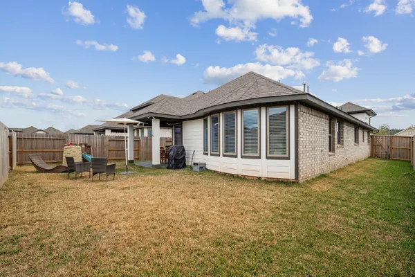a view of a house with backyard porch and sitting area