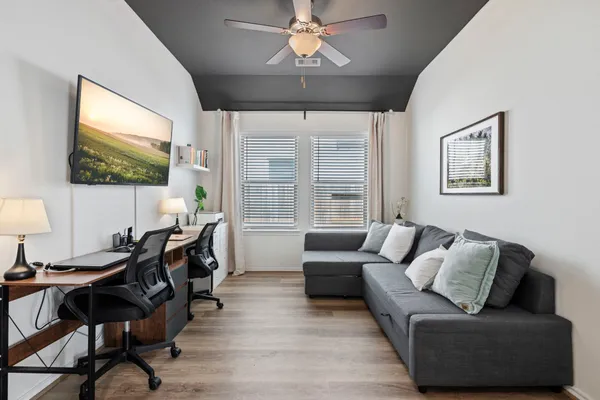a living room with furniture and a flat screen tv