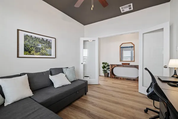 a bedroom with furniture and a wooden floor