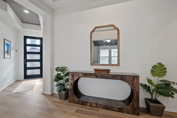 a living room with furniture and potted plants