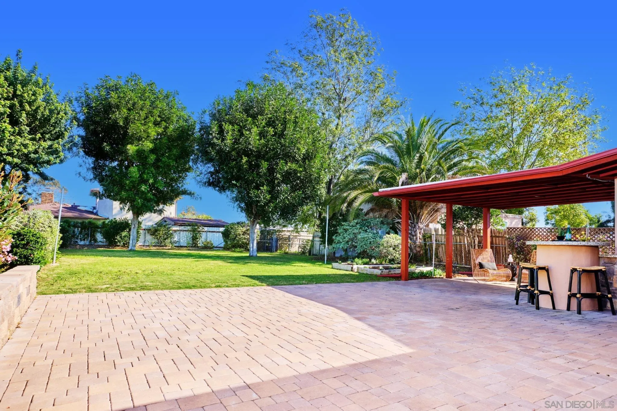 4591 68th Street La Mesa, CA 91942 - Photo 15 of 19 In addition to covered patio, is large patio space, uncovered. In the corner of the large backyard is a dog kennel.