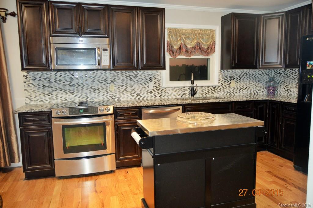 10060 Unity Church Road Mooresville, NC 28115 - Photo 20 of 22 a kitchen with a sink and a microwave